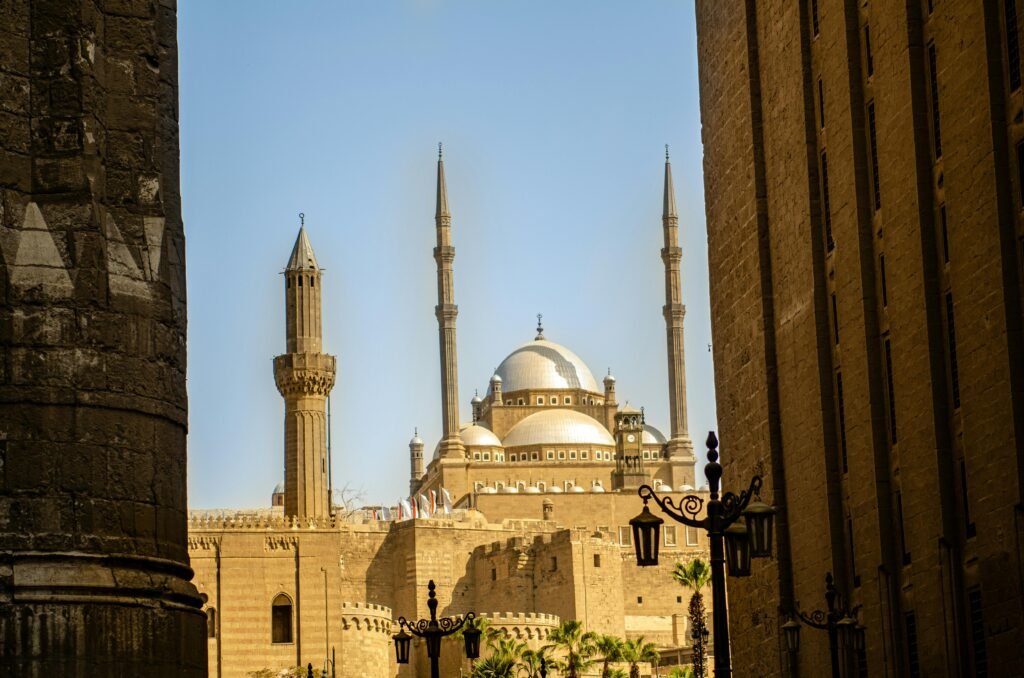 A stunning view of a mosque in Cairo featuring elegant minarets and a dome roof.